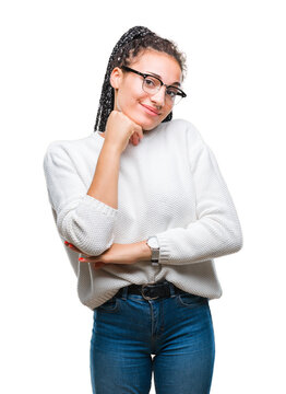 Young braided hair african american girl wearing glasses and sweater over isolated background with hand on chin thinking about question, pensive expression. Smiling with thoughtful face. Doubt concept