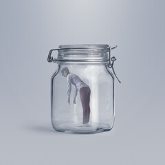 Scared woman trapped in a glass jar