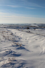 A snowy landscape with a blue sky