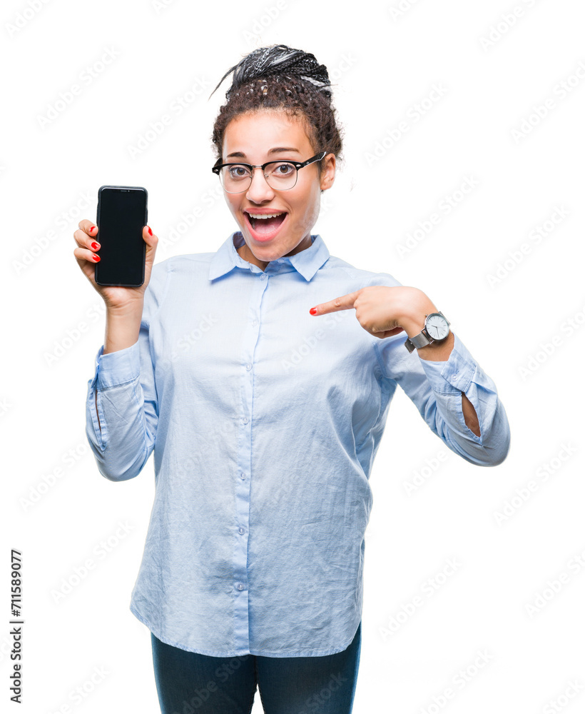 Canvas Prints Young braided hair african american business girl showing screen of smartphone over isolated background with surprise face pointing finger to himself