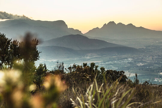 landscape image from a mountain down into valley at sunset.