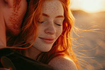 Close-up side view portrait of a beautiful woman with red hair and freckles kissing with her boyfriend with eyes closed while against sunset. - obrazy, fototapety, plakaty