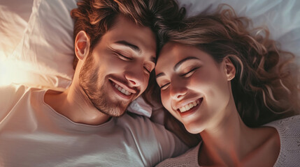 Close-up of happy couple is lying in bed together. Enjoying the company of each other.