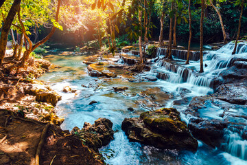 Beautiful of Huai mae khamin waterfall Srinakarin national park at Kanchanaburi thailand. Waterfall clear emerald water on autumn and summer season with rock for holiday relax on green tree in jungle. - Powered by Adobe