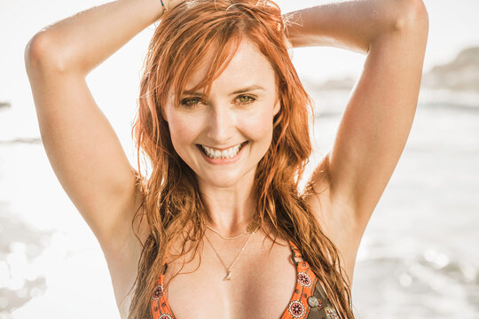 Portrait of young beautiful woman in a bikini on the beach