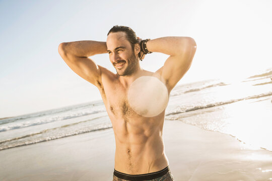 man hanging out on the beach at sunset