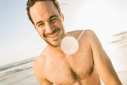 man hanging out on the beach at sunset