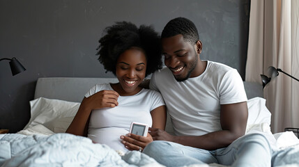 Parenthood, good news, baby expecting concept. Joyful dark skinned wife leans shoulder of her husband, look positively at pregnancy test, going to have child. Family couple on bed in modern apartment