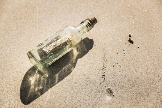 Message in a bottle lying on the beach