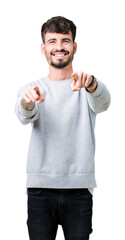 Young handsome man wearing sweatshirt over isolated background Pointing to you and the camera with fingers, smiling positive and cheerful