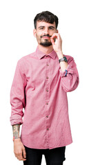 Young handsome man wearing pink shirt over isolated background mouth and lips shut as zip with...