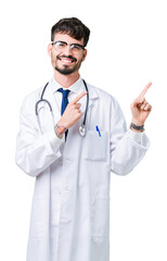 Young doctor man wearing hospital coat over isolated background smiling and looking at the camera pointing with two hands and fingers to the side.