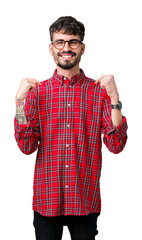 Young handsome man wearing glasses over isolated background looking confident with smile on face,...