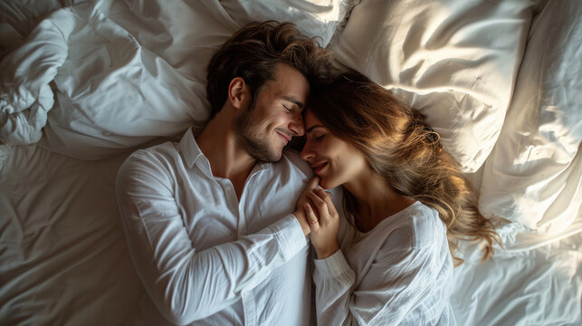 Top view beautiful young couple two family in casual white clothes lying in bed sleep woman hands folded under head on man shoulder relax spend time together in bedroom lounge home in own room house