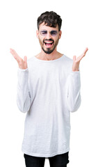 Naklejka premium Young handsome man wearing sunglasses over isolated background celebrating mad and crazy for success with arms raised and closed eyes screaming excited. Winner concept