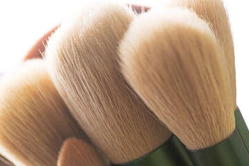 Macro bristles makeup brush,Brush tips in real-life color residue on bristles, isolated on white.