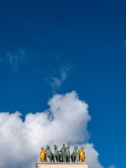 View of the equestrian group on the roof of the Arc de Triomphe du Carrousel in Paris under the Paris sky.