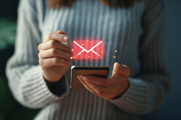 Person holding phone with glowing email icon