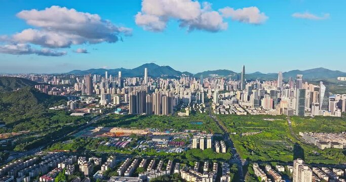 Aerial forward shot of Shenzhen Financial District skyline and natural environment