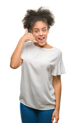 Young afro american woman over isolated background smiling doing phone gesture with hand and fingers like talking on the telephone. Communicating concepts.