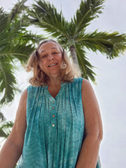 senior adult woman with palm tree