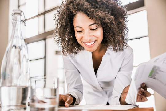 Portrait of businesswoman going through some paper work in the office