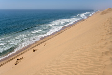 shore with dune slope and Atlantic waves from above at Sandwich Harbour, Namibia