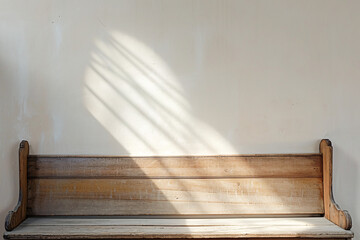 Wooden bench bathed in sunlight with wall shadows - obrazy, fototapety, plakaty