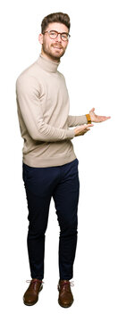 Young handsome business man wearing glasses Inviting to enter smiling natural with open hand