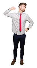 Young handsome business man stretching back, tired and relaxed, sleepy and yawning for early morning