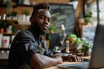 A young black male business owner runs a successful online and brick-and-mortar business.