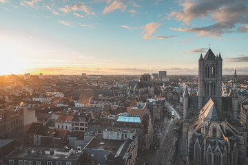 Watching the sunset over Ghent from the historic tower in the city centre. Romantic colours in the sky. Red light illuminating Ghent, Flanders region, Belgium