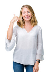 Beautiful young elegant woman over isolated background smiling doing phone gesture with hand and fingers like talking on the telephone. Communicating concepts.