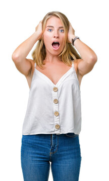 Beautiful young woman over isolated background Crazy and scared with hands on head, afraid and surprised of shock with open mouth