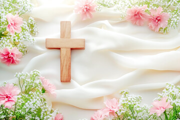 Wooden cross with tender pink spring flowers on white silk background. Religion background. Religious church holidays. Christianity Feast, Easter, Palm Sunday, Christening, church wedding. Copy space