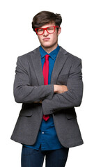 Young handsome business man wearing red glasses over isolated background skeptic and nervous, disapproving expression on face with crossed arms. Negative person.