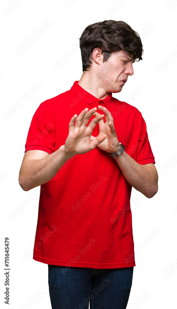 Wall mural Young handsome man wearing red t-shirt over isolated background disgusted expression, displeased and fearful doing disgust face because aversion reaction. With hands raised. Annoying concept. - Wall murals
