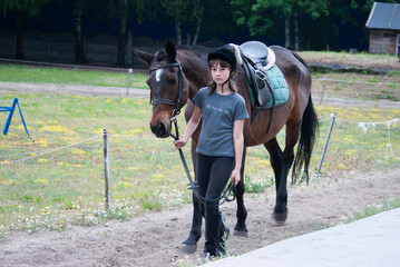 Teenage girl leading a horse