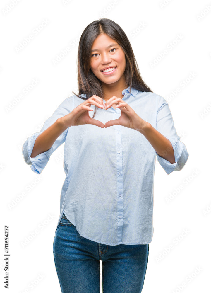 Sticker young asian business woman over isolated background smiling in love showing heart symbol and shape w