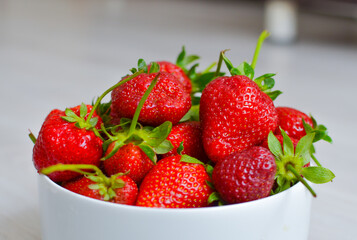 fresh ripe strawberry in white bowl on wooden tabel