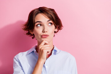 Portrait of creative minded person hand touch chin look empty space brainstorming isolated on pink color background