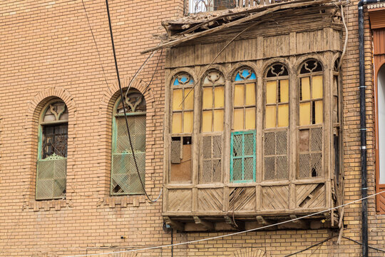 Basra, Iraq - 12 November 2022: Old wooden carved balcony and windows in old town of Basra
