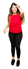 Obraz premium Young beautiful woman wearing casual t-shirt Smiling confident touching hair with hand up gesture, posing attractive