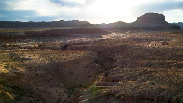 Drone flying towards Monument valley rock formations in Utah, USA. Aerial view of famous landmark in western USA. Cinematic drone footage.
