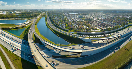 Above view of wide highway crossroads in Miami, Florida with fast driving cars. USA transportation...