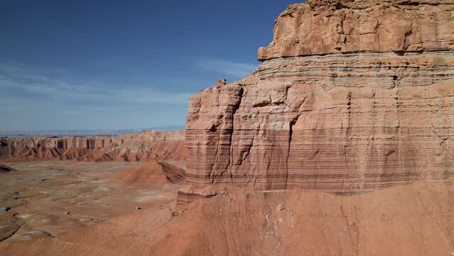 Panoramic aerial view to the red rocks butte of brick canyon formation crumbling from erosion. High cliffs of famous gorge canyon of red orange sand sandstone in dried sunny desert of western usa.