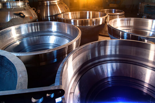 Close-up of large steel pipes at a machine-building plant.