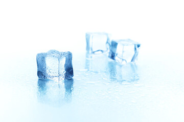 Close-up of a beautiful piece of ice with drops of water on a light background on a light...