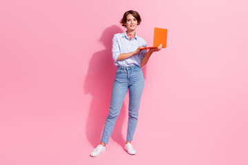 Full size photo of gorgeous manager girl hold wireless laptop coworking isolated on pink color...
