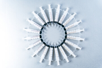 Free composition creating a circle with newly manufactured single-use syringes for medical or...